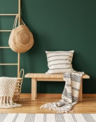 a chair with a basket and a hat on it