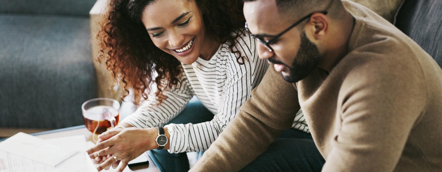 a man and a woman looking at a laptop