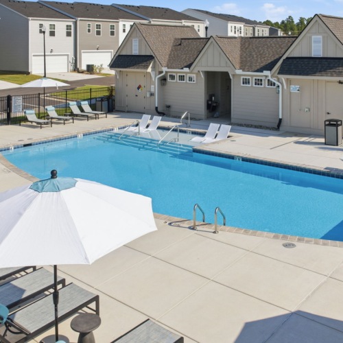 pool surrounded by chairs in a courtyard
